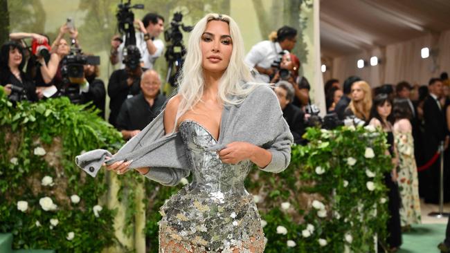 Kim Kardashian arrives for the 2024 Met Gala in a grey cardigan.