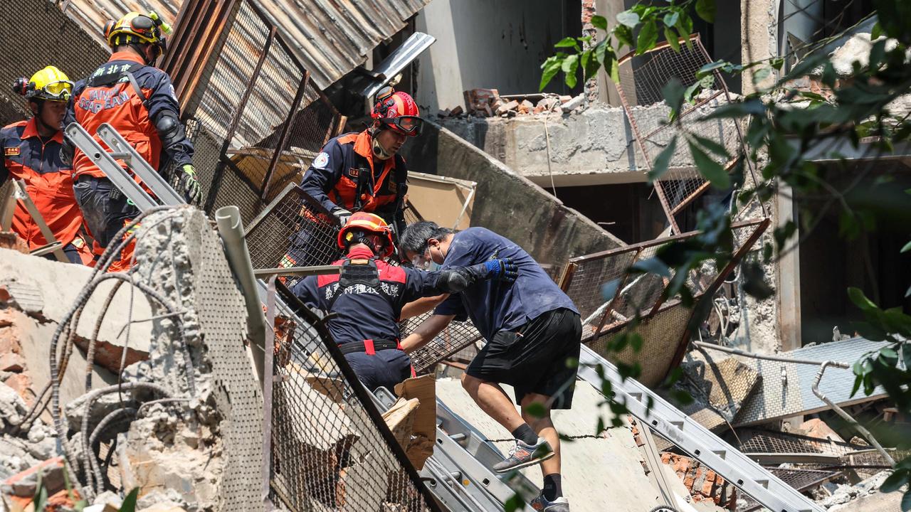 Rescuers are working hard to help people still trapped. Picture: CNA / AFP