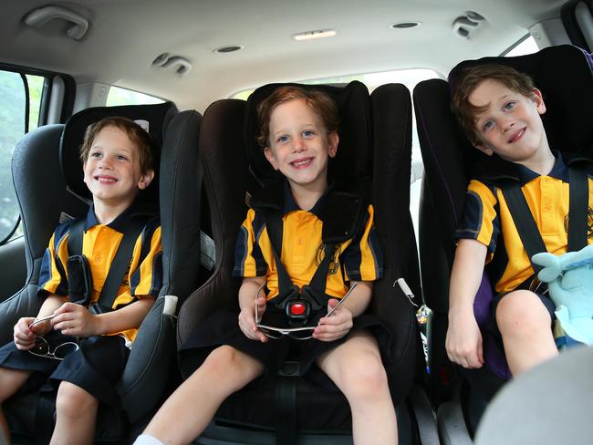 Identical triplets Grayson, Tiernan and Leon McGregor in the car and ready to ehad to school. Pic: AAP Image/Sue Graham