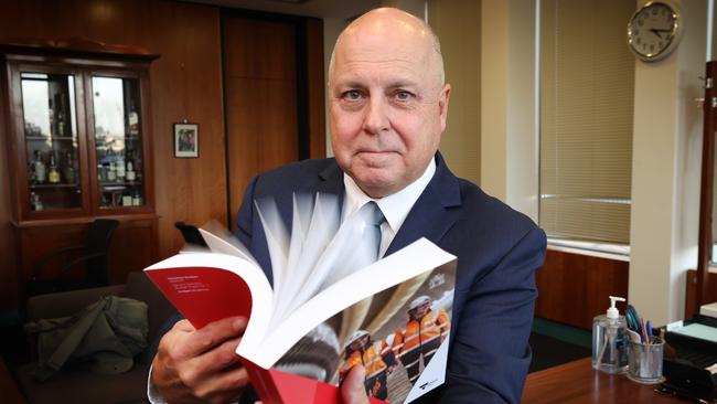 Victorian Treasurer Tim Pallas in his office with the 2023-2024 State Budget report. Picture: David Caird