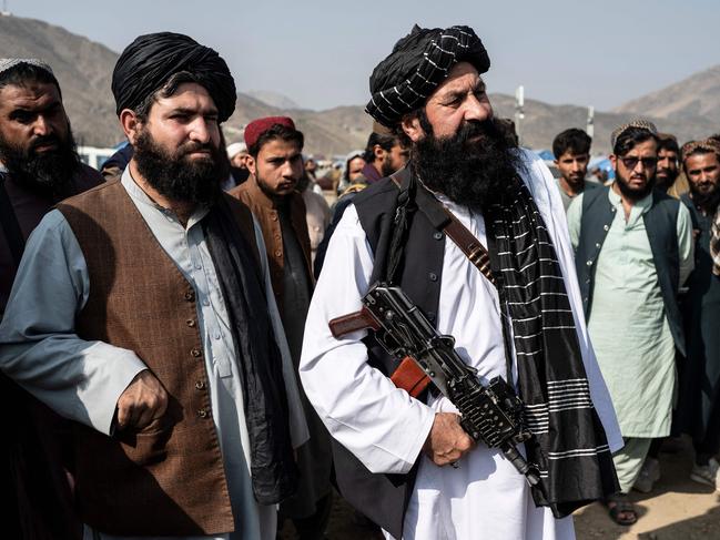 (FILES) Afghanistan's minister for refugees Khalil Haqqani (C) looks on as he arrives to inspect a refugee camp near the Afghanistan-Pakistan Torkham border in Nangarhar province on November 2, 2023. The Afghan minister for refugees was killed on December 11, 2024, in an explosion at the ministry's offices in the capital Kabul, a government source told AFP. (Photo by Wakil KOHSAR / AFP)