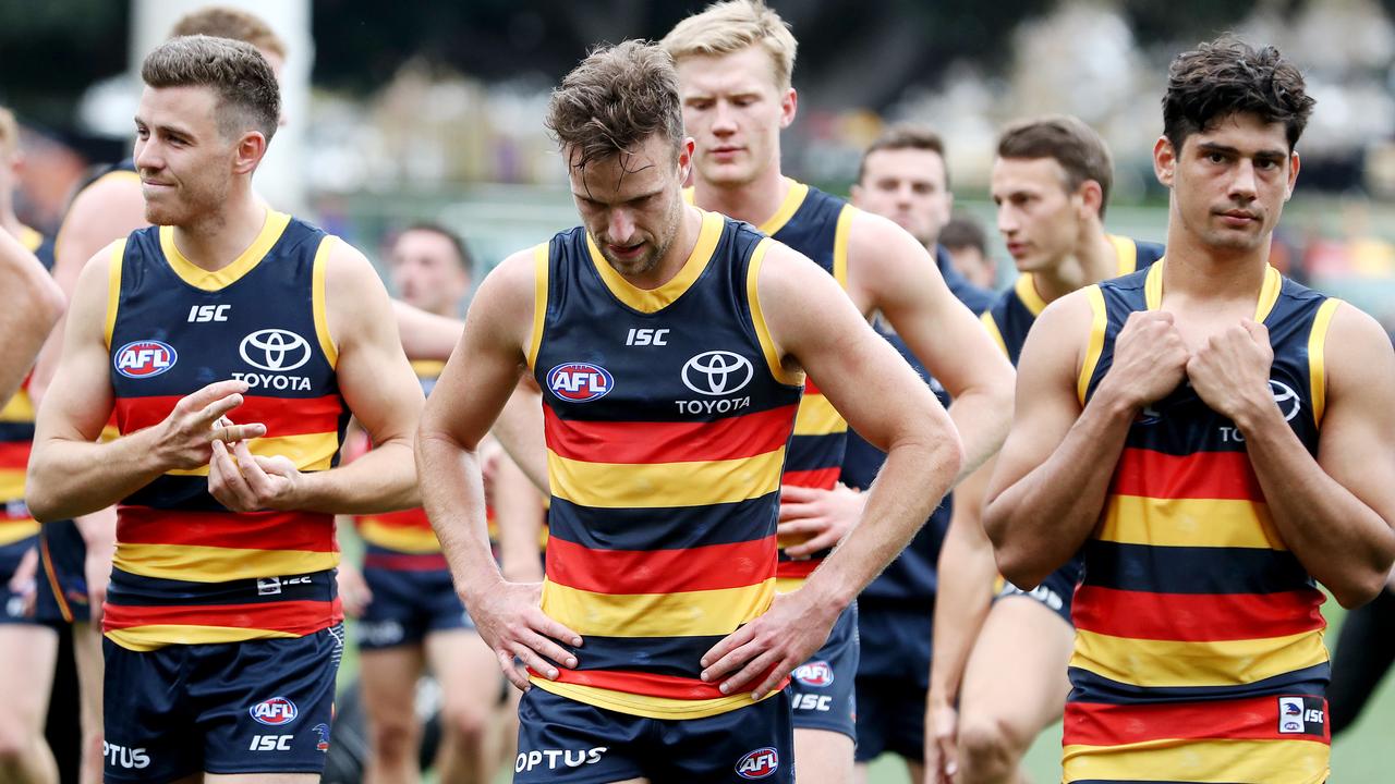 Adelaide players leave the field after another loss on Sunday. Picture: Sarah Reed