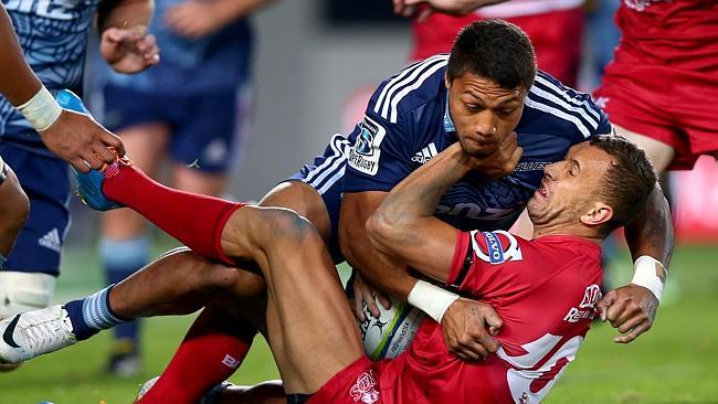 Quade Cooper is driven into the Eden Park turf by George Moala.