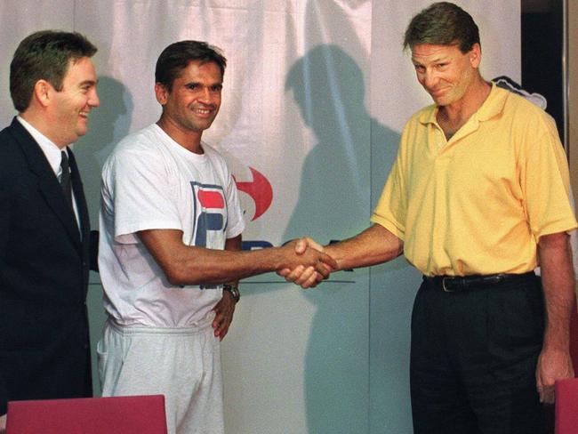 Eddie McGuire and Nicky Winmar, centre, and Sam Newman (far right) shake hands after the Footy Show’s racism scandal in 1999. Picture: News Corp Australia