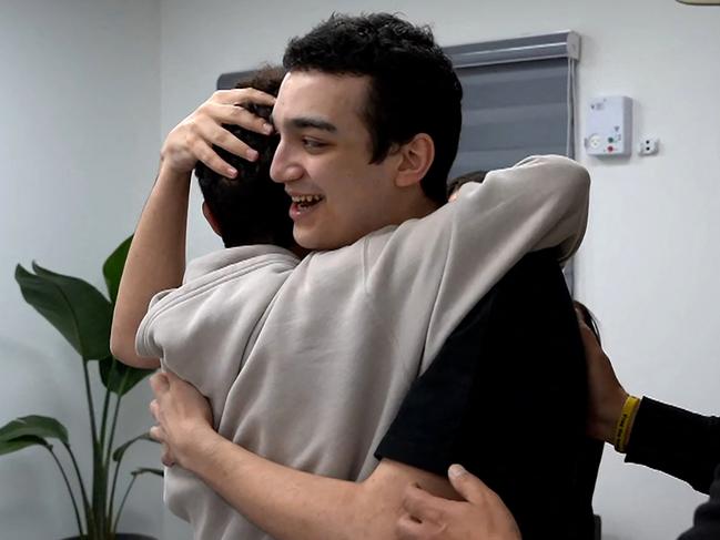 Newly-released Israeli-US hostage Edan Alexender reuniting with members of his family at an undisclosed location in Israel. Picture: Israeli Army/AFP
