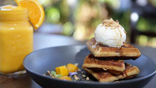 Waffle french toast with mango and peanut crumb, coconut lime ice cream and chai syrup and mango frappé. Picture: Martin Lange.