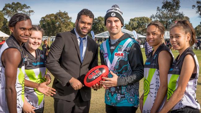 Matthew Karpany-Carter and Chad Wingard with players at the Aboriginal Power Cup carnival. Picture: Mark Piovesan