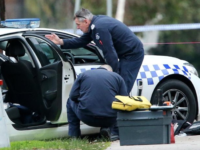 Police probe the scene of the shooting of Constable Ben Ashmole.