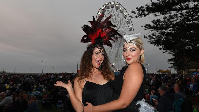 Revellers Rebecca Kuchenmeister and Candice Berzins wait at the foreshore for the fireworks on New Year’s Eve in Glenelg on December 31, 2019. Picture: Tracey Nearmy