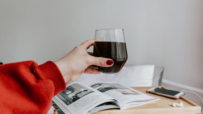 Even though red wine may not be your first drink of choice this summer, experts say a cheap bottle of red may be key to keeping your head (and wallet) happy. Image: Unsplash