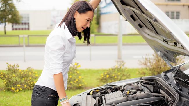 Woman looking at broken cars motor Photo: istock