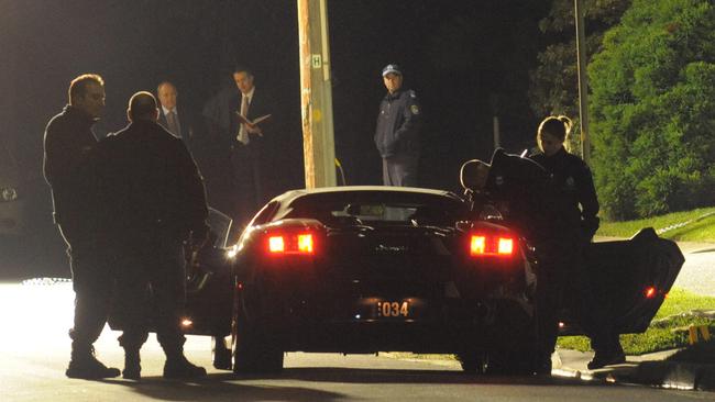 Police inspect Fadi’s car after the shooting outside his home.