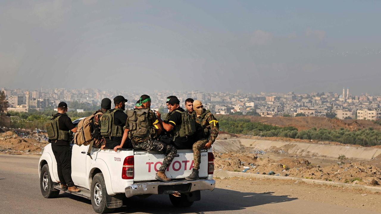 Palestinian militants of the Ezzedine al-Qassam Brigades move towards the Erez crossing between Israel and the northern Gaza Strip. Picture: AFP