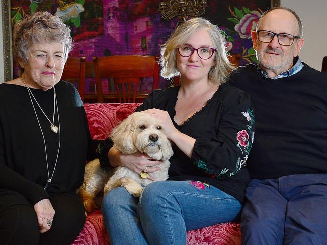 Janine Phillips is a COVID-19 survivor. She is pictured with her parents Shaz and Gerry and their dog Zac. Picture: Nicki Connolly