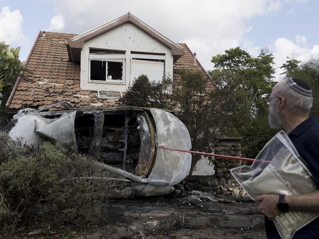 A man walks with prayer talit at a scene of a house that was hit by a rocket fired from Lebanon on September 22 in Moreshet, Israel. Hezbollah claimed to have attacked military targets inside Israel, with some landing near the city of Haifa. Picture: Amir Levy/Getty Images