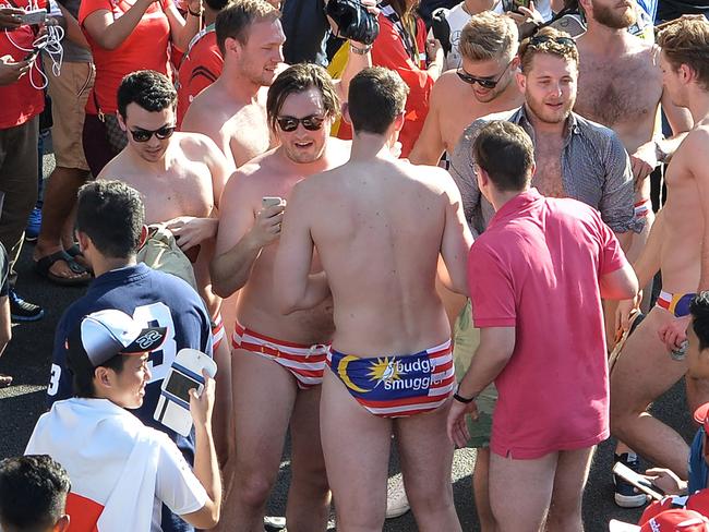 This picture taken on October 2, 2016 shows spectators with swimwear bearing a Malaysian flag during the Formula One Malaysian Grand Prix in Sepang. The spectators were arrested around the time the race ended on October 2 and were being investigated for 