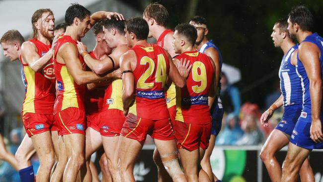 Action from the AFL match between the Gold Coast Suns and the North Melbourne Kangaroos, held at Cazalys Stadium, Cairns. The Suns celebrate a goal by Alex Sexton (centre). PICTURE: BRENDAN RADKE