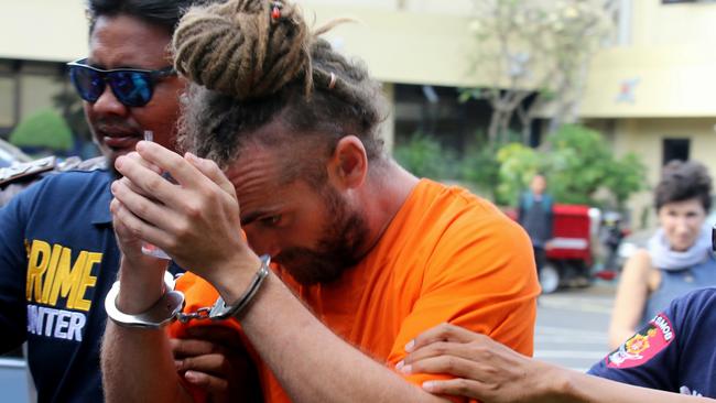 David Taylor is escorted by police back to his cell after meeting with British Consulate staff at Denpasar Police Station. Picture: Lukman S. Bintoro.