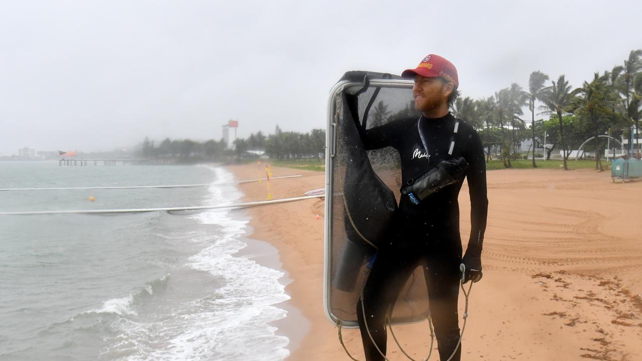 Wet weather in Townsville. Lifeguard Jan Fabricius still dies a sweep for stingers at the Strand. Picture: Evan Morgan