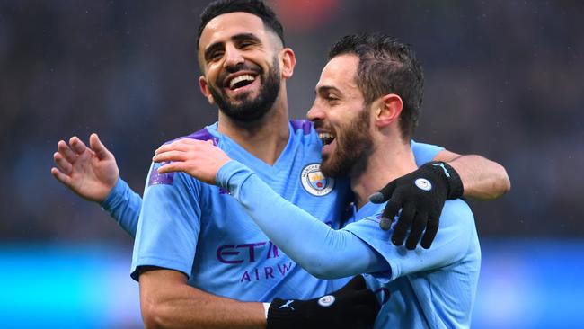 Bernardo Silva celebrates Manchester City’s second goal with Riyad Mahrez.