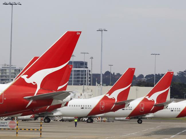 The tails of Qantas planes are lined up at Sydney Airport in Sydney, Sunday, Oct. 30, 2011. Qantas Airways grounded all of its aircraft around the world indefinitely Saturday due to ongoing strikes by its workers. (AP Photo/Rick Rycroft)