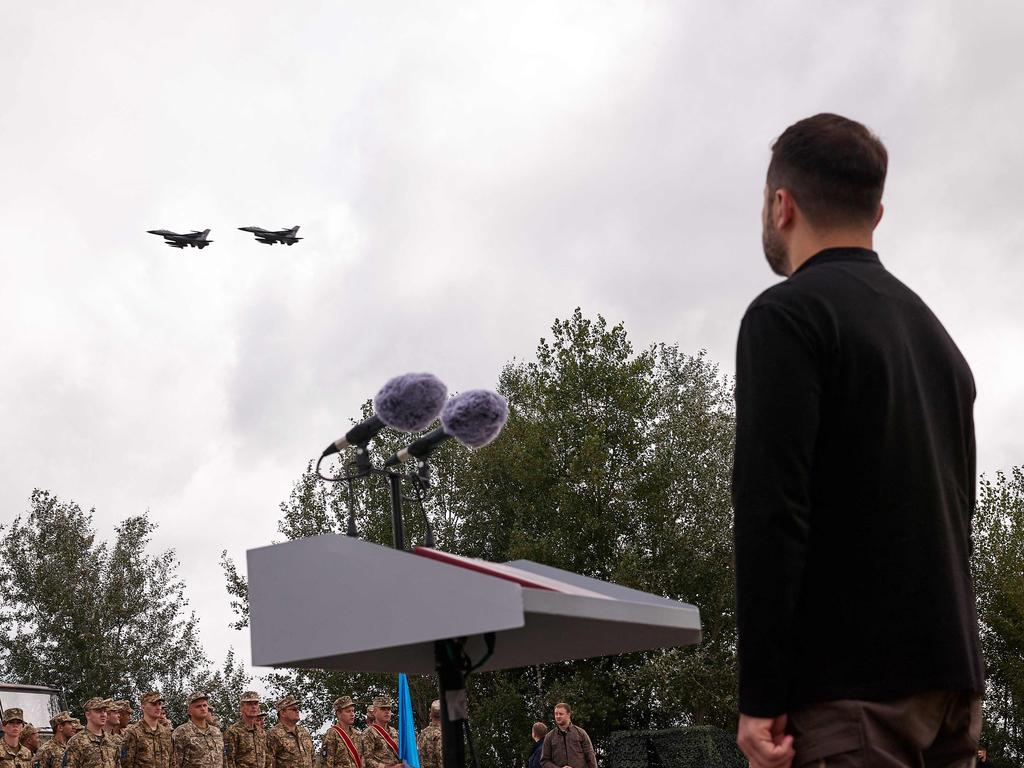 Ukraine's President Volodymyr Zelensky watches a pair of F16 jets flying during Ukraine's Air Force Day celebrations at an undisclosed location, amid the Russian invasion of Ukraine. Picture: AFP