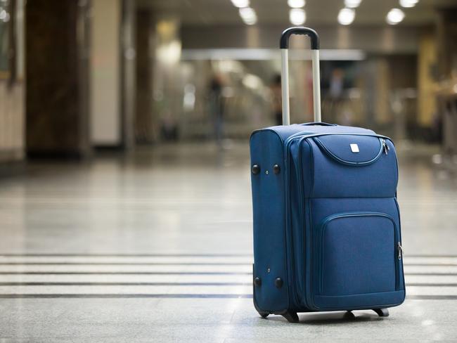 ESCAPE: UGC - 3MAR19 - Large blue wheeled suitcase standing on the floor in modern airport terminal. Copy space Picture: iStock