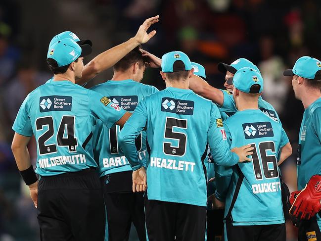 Xavier Bartlett is congratulated by his Brisbane Heat teammates after taking the wicket of Sydney Thunder’s Alex Hales at Manuka Oval. Picture: Mark Kolbe/Getty Images