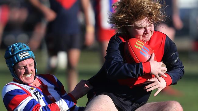 Swifts Creek’s Jacob Westland is caught in a tackle from Lindenow South’s Jamie Donnelly, 52, Lindenow South. Picture: Yuri Kouzmin