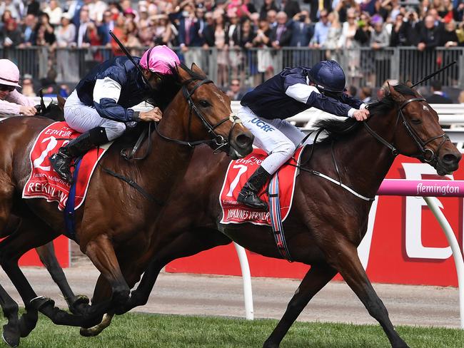 Rekindling, ridden by jockey Corey Brown (left), comes at Johanees Vermeer to win the Melbourne Cup. Picture: AAP