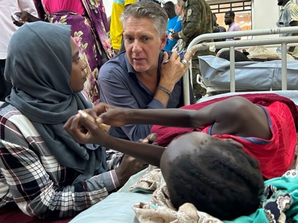 James Elder with interpreter Sara, speaking with Narmin, who was injured by shelling and underwent surgery. Picture: UNICEF