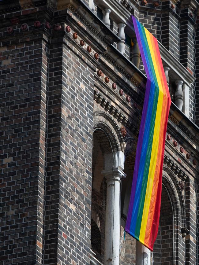 LGBT rainbow flag hangs from on the steeple of the parish church in the Breitenfeld quarter in Vienna. Picture: AFP