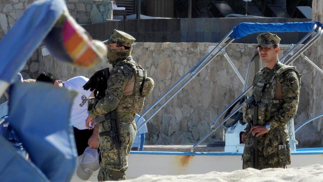 Mexican Marines patrol the beach ahead of the wedding. Picture: Nathan Edwards