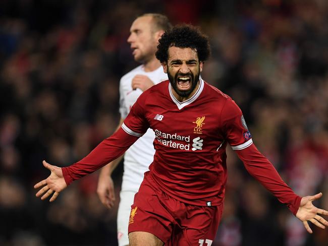 (FILES) This file photo taken on December 6, 2017 shows Liverpool's Egyptian midfielder Mohamed Salah celebrating scoring their seventh goal during the UEFA Champions League Group E football match between Liverpool and Spartak Moscow at Anfield in Liverpool, north-west England.  Prolific goalscorers Mohamed Salah of Egypt was named on December 18, 2017 among the three finalists for the African Player of the Year award.  / AFP PHOTO / Paul ELLIS