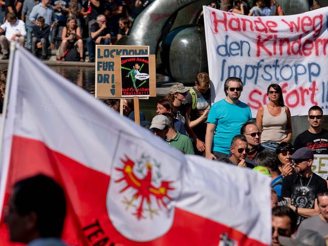 Demonstrators with the Austrian national flag take part in a protest against governmental coronavirus pandemic measures, in Vienna. Picture: AFP