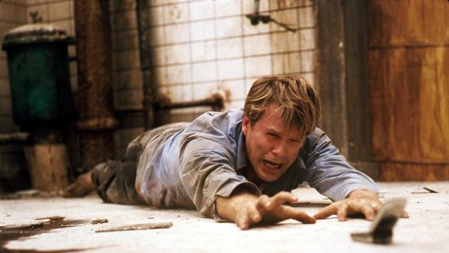 Lawrence Gordon, played by Cary Elwes struggles to survive Saw.