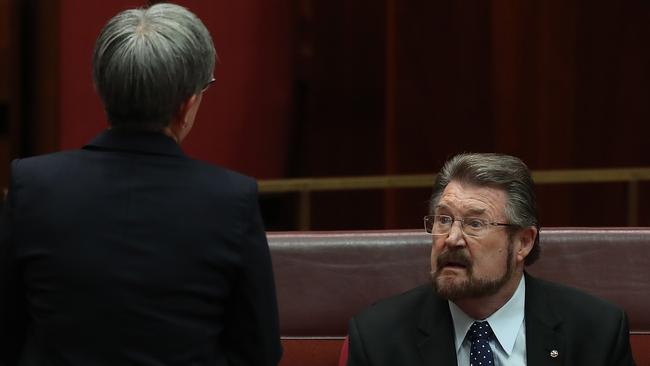 Penny Wong talks to Derryn Hinch in the Senate Chamber. Picture: Kym Smith