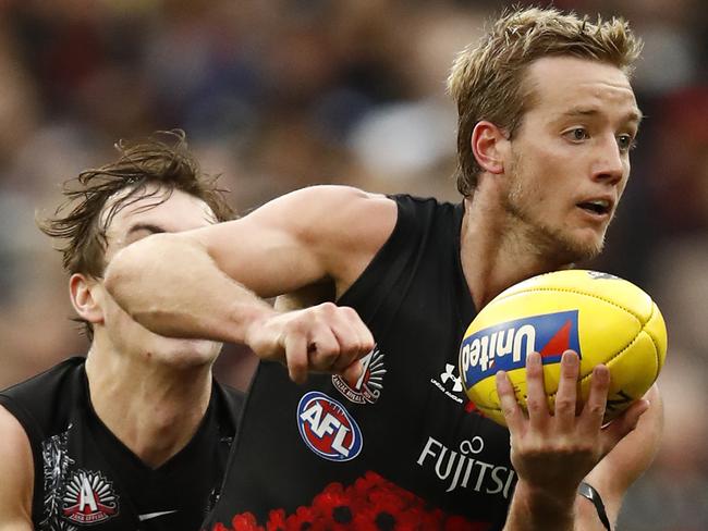 MELBOURNE, AUSTRALIA - APRIL 25: Darcy Parish of the Bombers  handballs during the round six AFL match between the Collingwood Magpies and the Essendon Bombers at Melbourne Cricket Ground on April 25, 2021 in Melbourne, Australia. (Photo by Darrian Traynor/AFL Photos/via Getty Images )