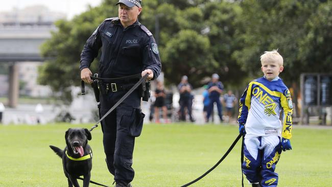 Finn with a member of the dog squad when he was made a honorary police officer for the day on March 6. Picture: John Feder.