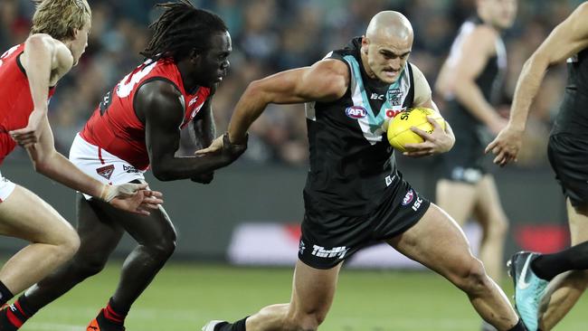 Port’s Sam Powell-Pepper tries to shake off Essendon’s Anthony McDonald-Tipungwuti. Picture: Sarah Reed