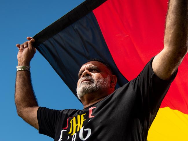 Michael Long stands with the Aboriginal flag at Gardens Oval, Darwin, ahead of the AFL's Dreamtime Round. Picture: Che Chorley