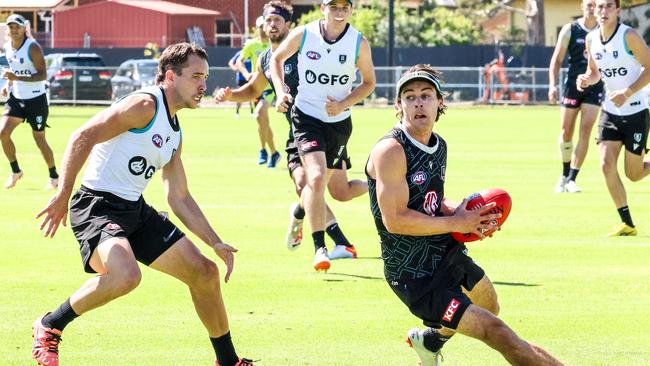 Port Adelaide captain Connor Rozee getting chased by Francis Evans Picture: Russell Millard Photography