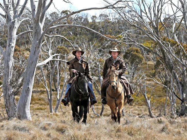 Peter Cochran and Bec Atkinson from Cochran Horse Treks riding through the Kosciuszko National Park. Picture: Stephen Cooper