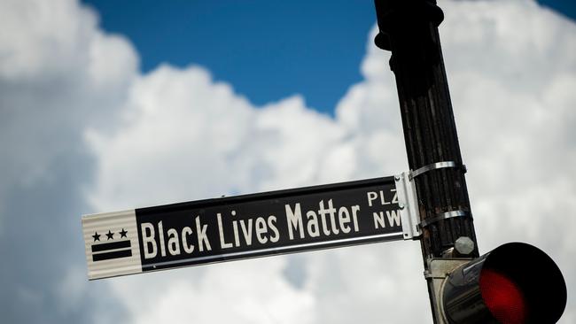 A new street sign that reads "Black Lives Matter Plaza NW" can be seen at the intersection of H and 16th Street near the White House.