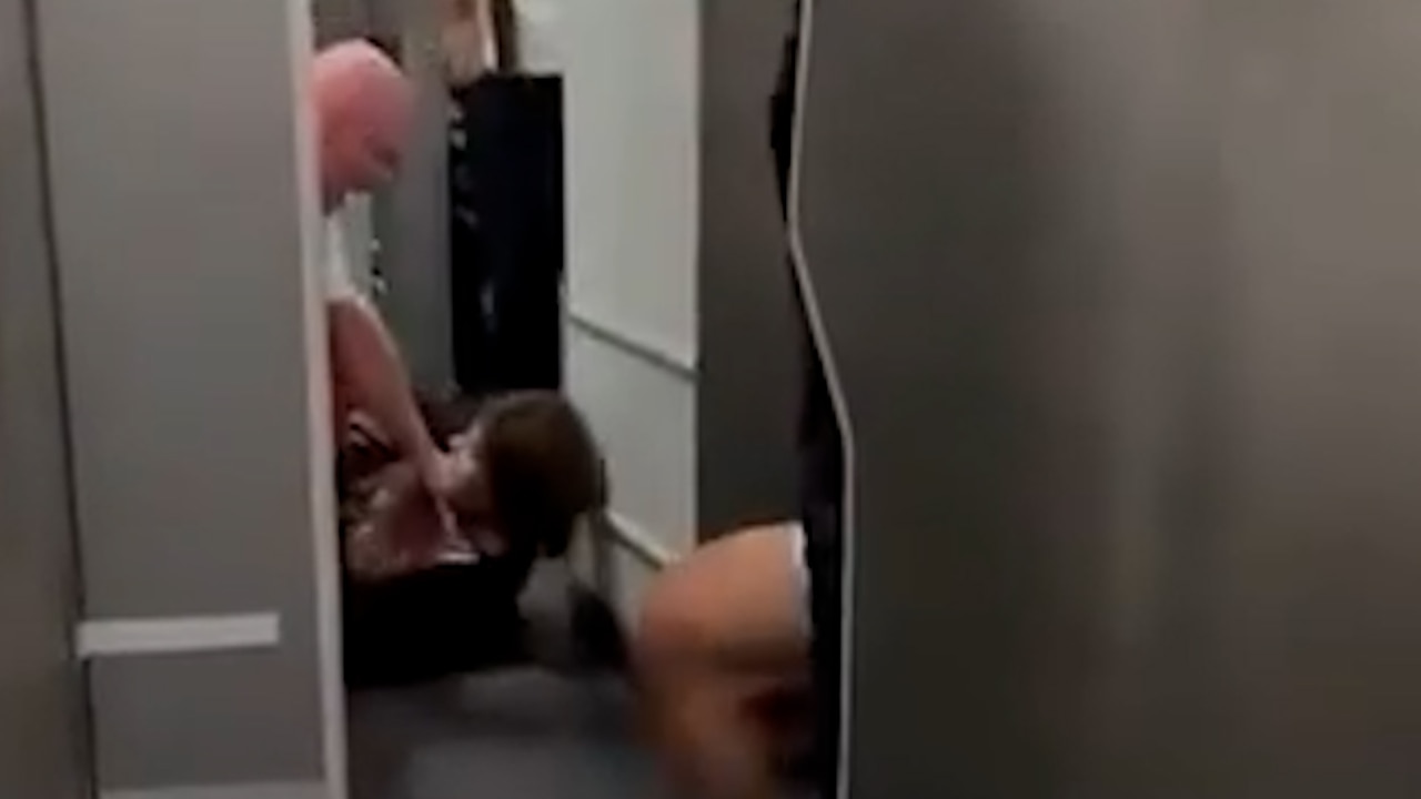 Flight attendants wrestle female passenger to ground after she tried to storm cockpit