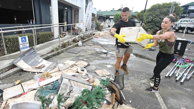 The clean up of mud, water debris in Jindalee, after floods and rain swamped Brisbane. Picture: Lyndon Mechielsen