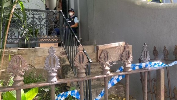 Police guard the property on Cleveland St, Redfern where Mr Bouggas was arrested.