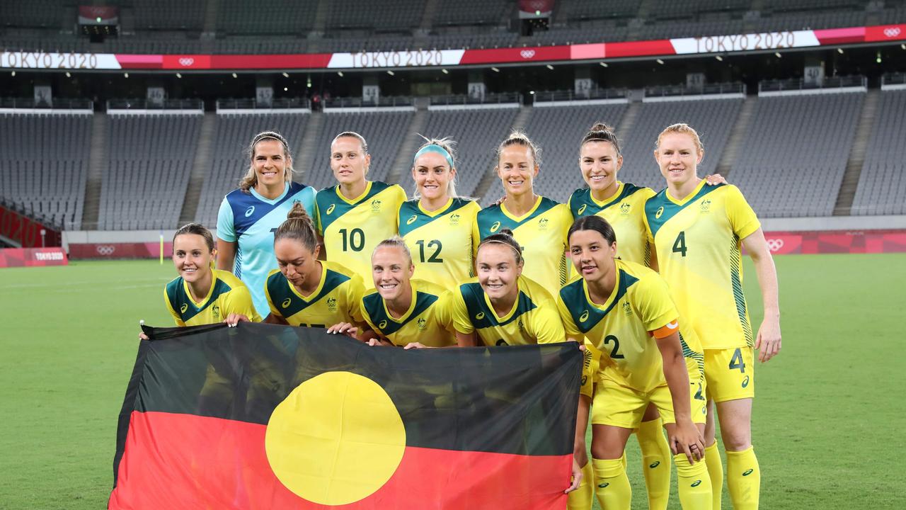 The Matildas hold an Aboriginal flag ahead of their match against New Zealand at the Tokyo Stadium in Tokyo on July 21, 2021. Photo: AFP