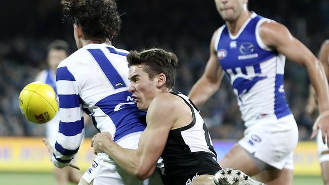 Connor Rozee tackles North Melbourne’s Jasper Pittard on Friday night. Picture SARAH REED