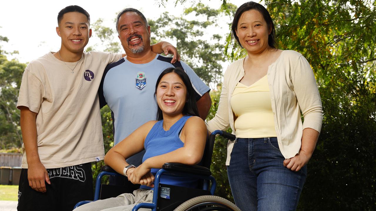 Polly Mok, 18, with her parents Jason and Philippa and brother Jobey, 15, at home in Dural. Functional Neurological Disorder (FND) has left her without the use of her legs and occasionally the inability to speak. Picture: Jonathan Ng
